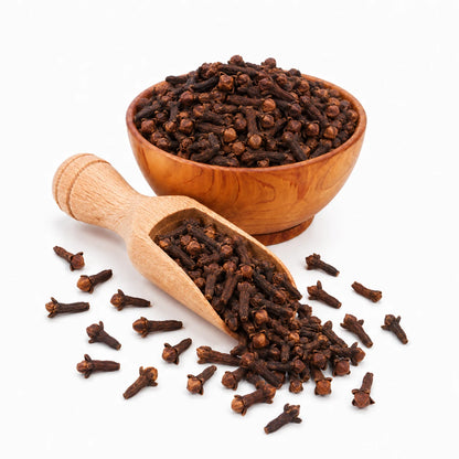 Wooden bowl and scoop filled with cloves on a white background