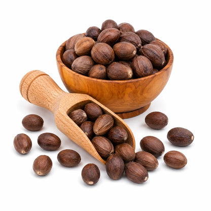 Wooden bowl and scoop filled with brown nuts on a white background