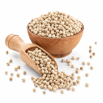 Wooden bowl and scoop filled with white peppercorns on a white background