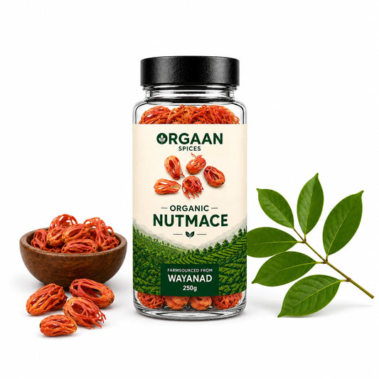 Jar of Orgaan organic nutmace with a bowl of nutmace and leaves on a white background